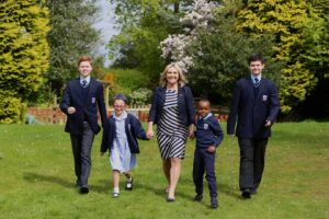 Mrs Ania Hildrey centre with Abbots Lea School students photo taken pre COVID 19 Liverpool school selected for Ofsted pilot